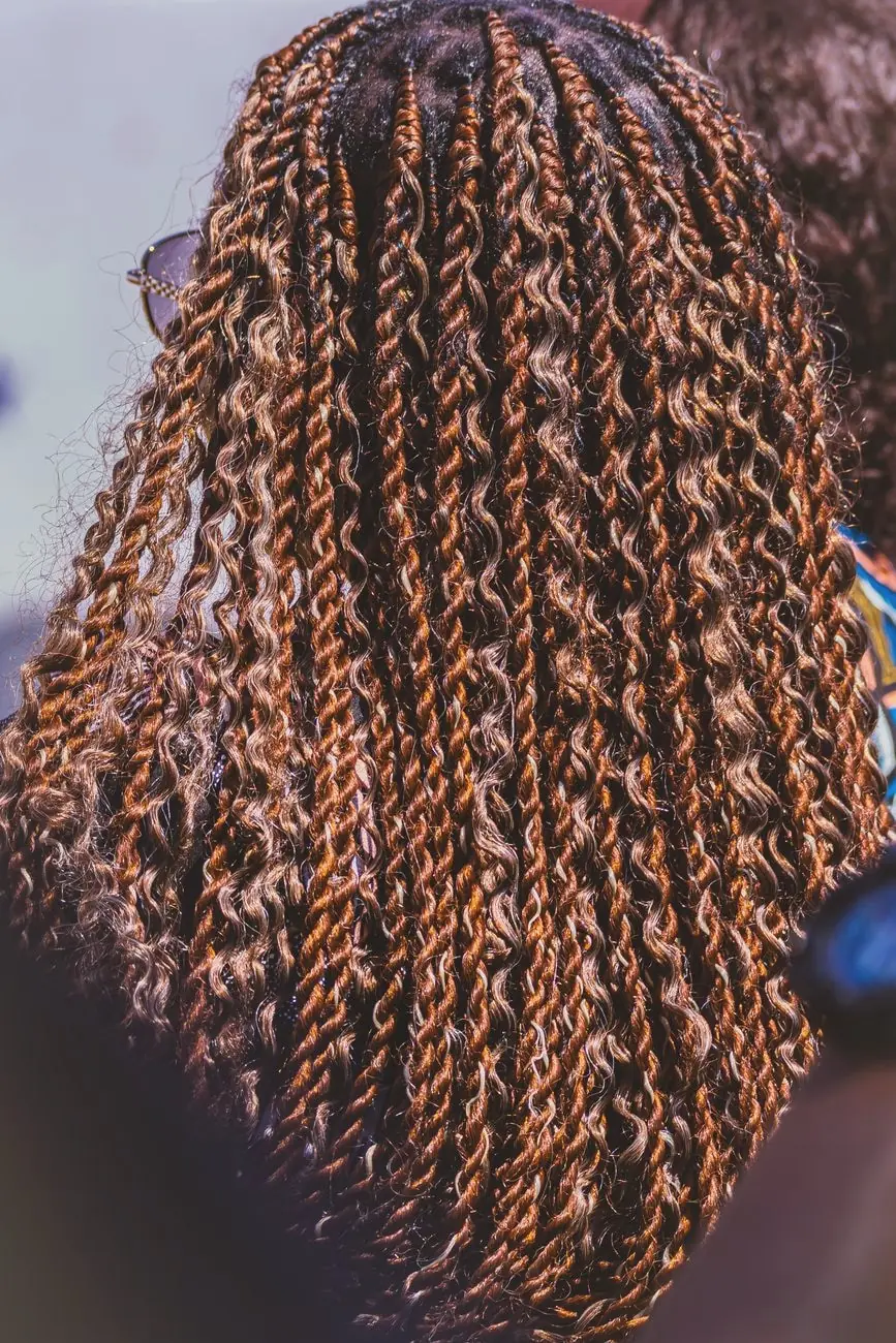 Copper-coloured twists and loose curls filling the frame